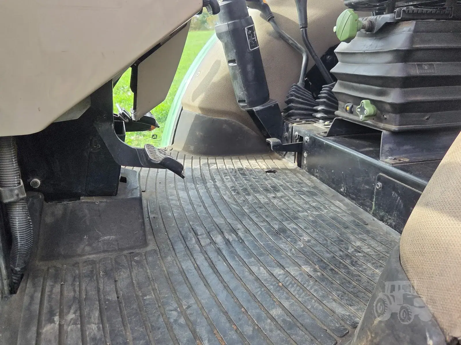 img (24) 2010 John Deere 5101E tractor footwell with rubber mat and control pedals.