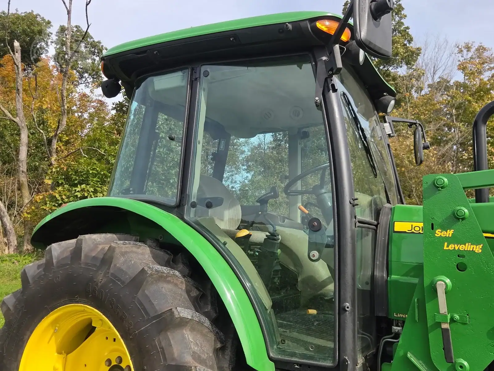 img (4) 2010 John Deere 5101E tractor with enclosed cab and large rear tires.