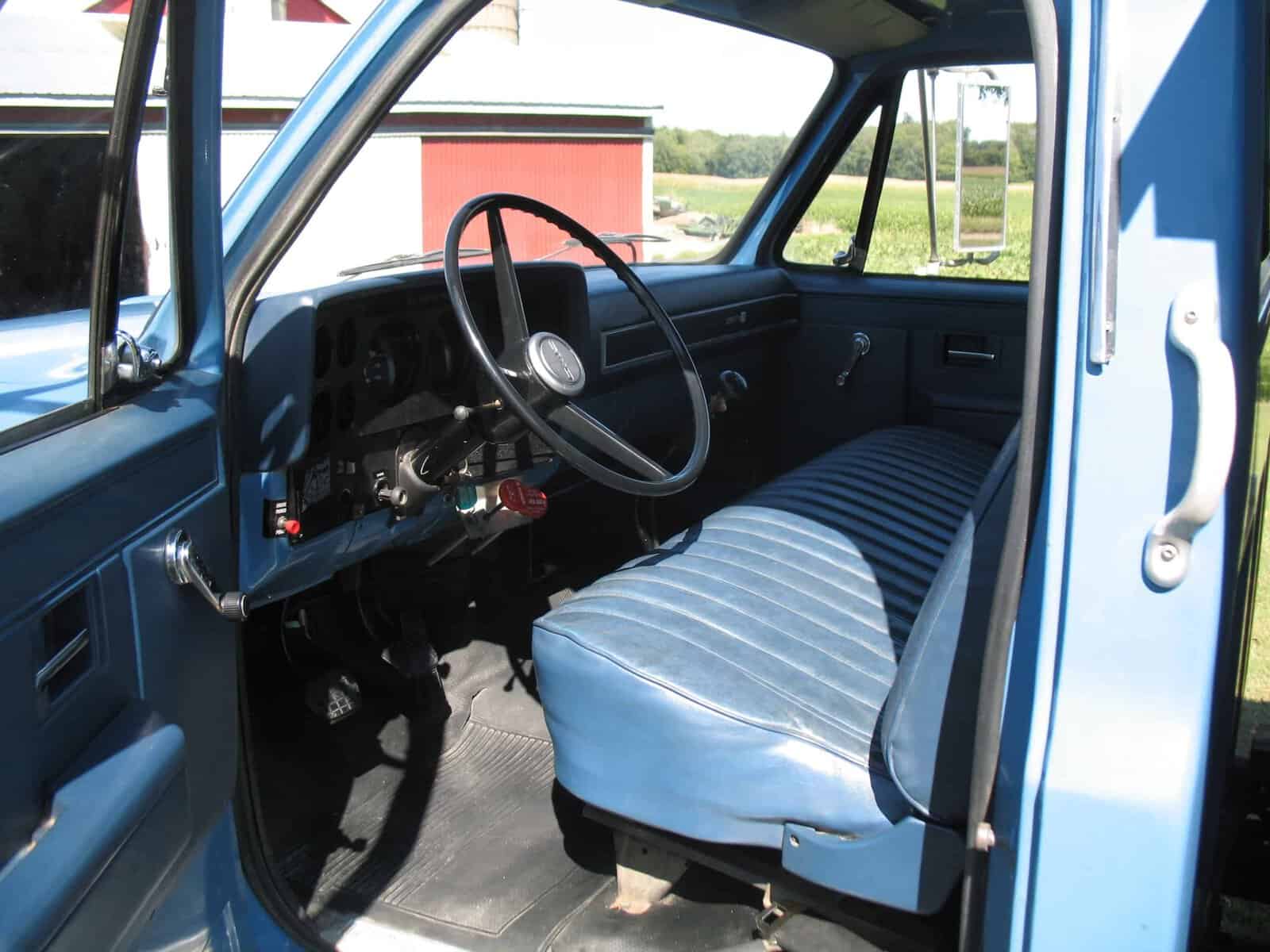 1985 GMC C7000 Grain Truck Interior 1985 GMC C7000 grain truck cab interior with blue bench seat and manual steering.