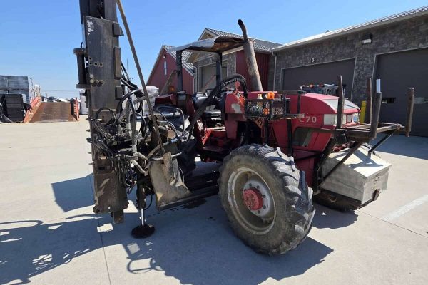 Red McCormick C70 tractor with log cabin pro driver attachment and large rear tires.