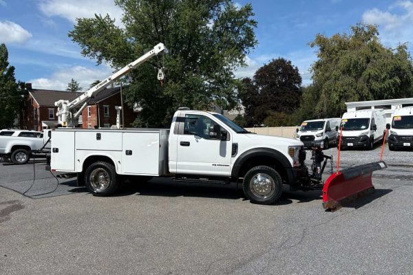 2018 Ford F-550 Super Duty XL utility truck with snow plow and bucket lift.