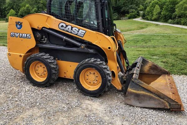 CASE SV185 skid steer loader with bucket attachment on gravel surface.