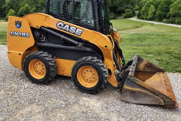 CASE SV185 skid steer loader with bucket attachment on gravel surface.