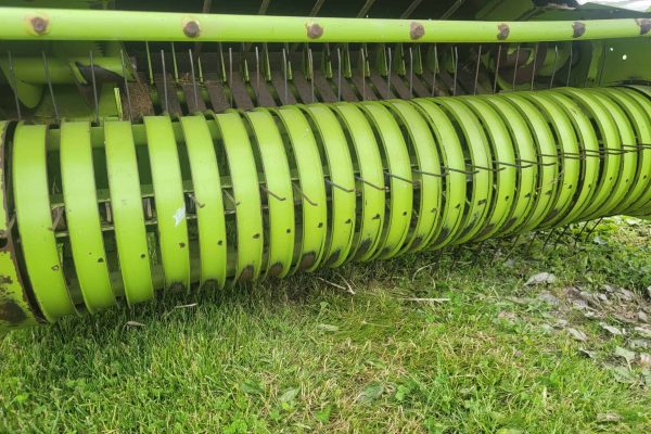 John Deere 6000 Series rotary hay rake, green color, used for agricultural hay collection.