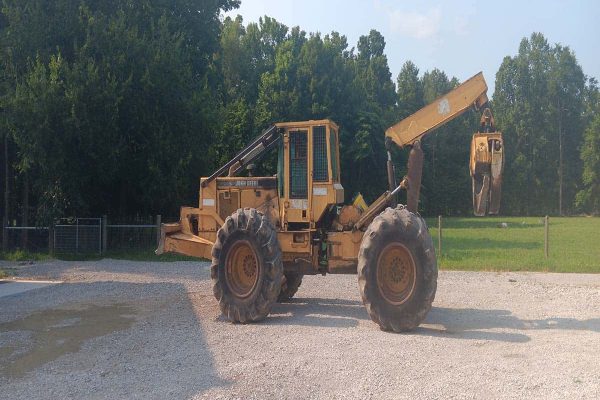John Deere 748 wheel loader with front bucket and rear hydraulic arm, yellow color, parked on gravel surface.