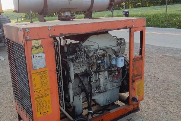 Orange portable generator with exhaust stack and engine components visible.