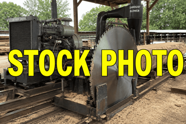 Detroit Diesel engine connected to a large circular saw in a sawmill setting.