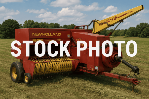 New Holland 565 hay baler with yellow pickup reel and red body in a field.