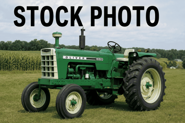 Oliver 1550 tractor with green body and large rear tires on a farm field.