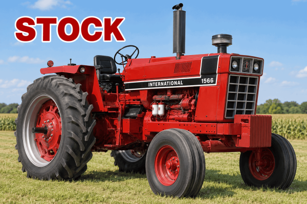 International Harvester 1566 tractor with red body and black exhaust pipe in a field.