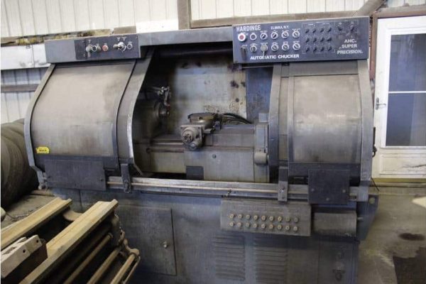 Industrial automatic chucking machine with control panel, used for precision machining in manufacturing facilities.