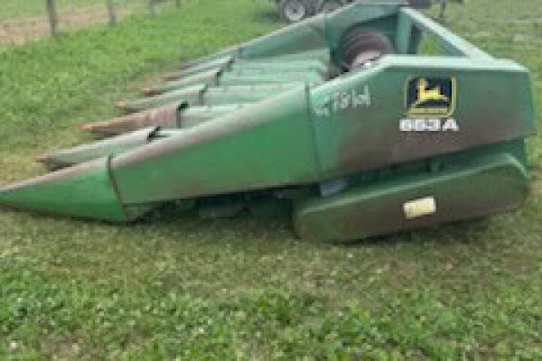 John Deere 653 6-Row All-Crop Head with green finish and visible cutting mechanism.