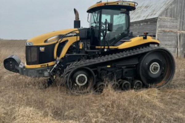 2013 Challenger MT855C tracked tractor with cab and rubber tracks on a farm field.