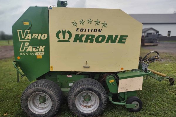 Krone Vario Pack round baler with green and white exterior, large tires, and branding visible.