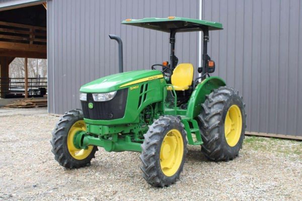 Green John Deere 5055E tractor with yellow wheels, 2020 model, outdoor setting.