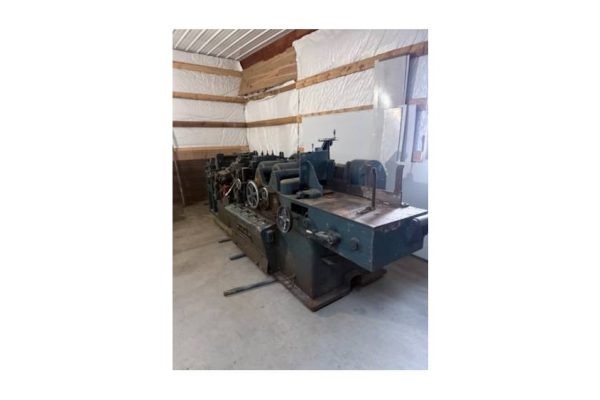 Industrial metalworking lathe machine in a workshop setting.