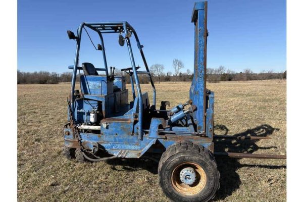 A.LT tag: Used blue forklift with lifting mast on open field, no visible year or model.
