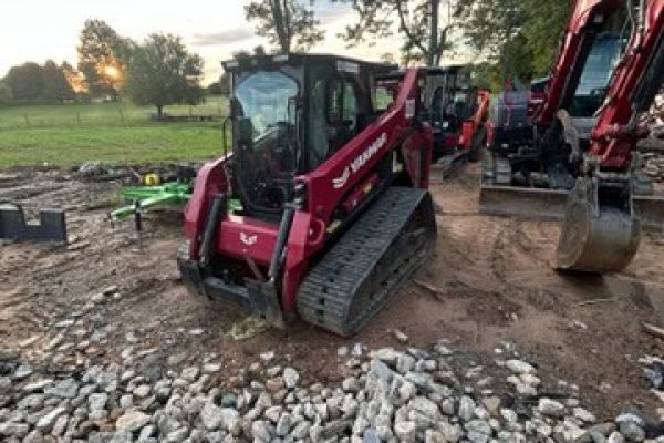 2024 YANMAR TL100VS compact track loader with enclosed cab and rubber tracks on construction site.