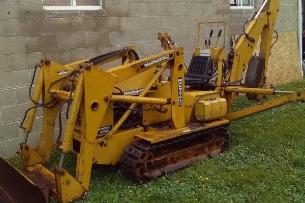 Yellow Mecalac 6MDX mini excavator with tracked undercarriage and hydraulic arm.