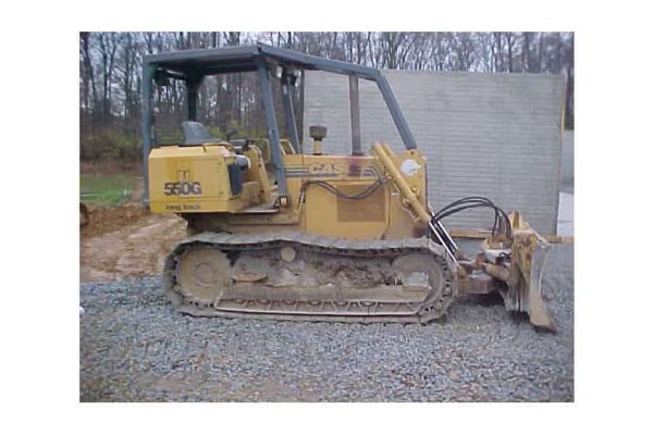 Caterpillar 550G compact track loader with blade attachment, yellow, used for construction and landscaping.