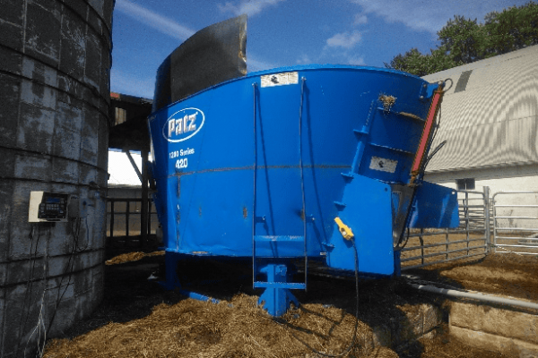 Blue PATZ 420 stationary TMR mixer with cab and mixing chamber, used in livestock feed operations.