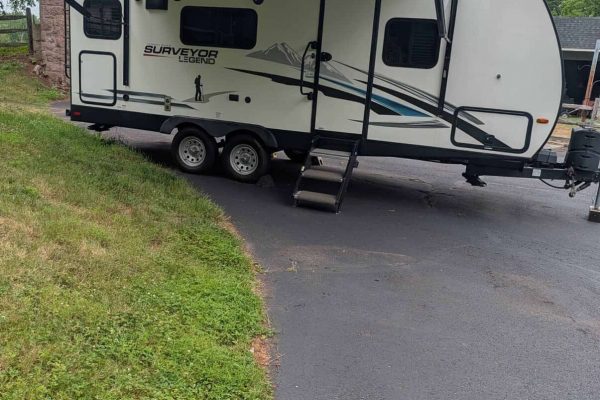 2021 Forest River Surveyor 203RLKE travel trailer with slide-out and awning.