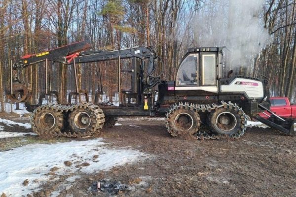 2017 Logset forwarder with tracked wheels and cab in a wooded area with snow.