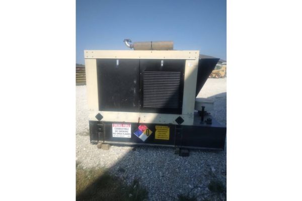 Industrial generator unit with black and beige casing, outdoor setting, no visible branding or model details.