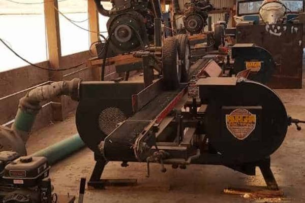 Morgan single head resaw machine with large circular saw and control panel inside warehouse.