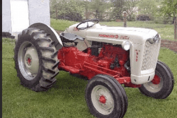 Vintage 1950s Massey Ferguson 35 tractor with red and white color, large rear tires, and open operator seat.