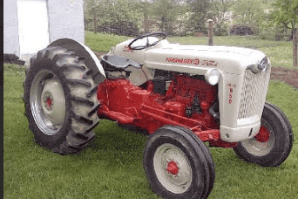 Vintage 1950s Massey Ferguson 35 tractor with red and white color, large rear tires, and open operator seat.