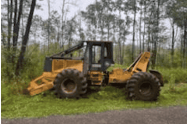 Yellow Caterpillar wheel loader with front bucket attachment on grassy area.