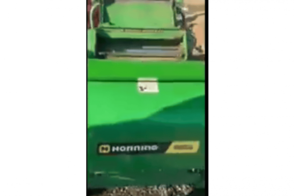 Green John Deere 2020 lawn mower with cutting deck and engine, ideal for residential and commercial grass maintenance.