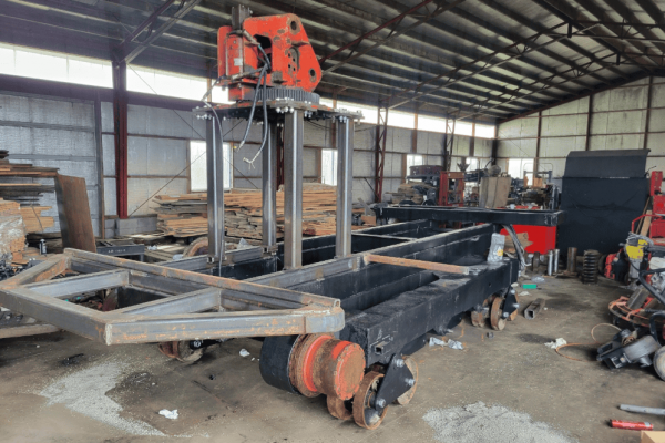 Heavy-duty industrial cutting or welding machine in a warehouse setting.