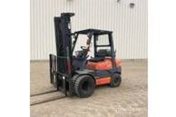 Forklift truck with orange and black body, lifting equipment in a warehouse environment.