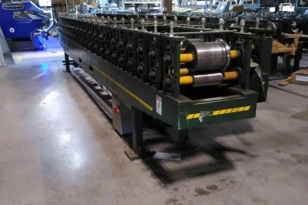 ACCUFORM overhead door trim machine with rollers and frame in industrial setting.