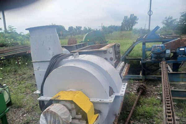 Industrial metal processing equipment with large cylindrical component and motorized parts.