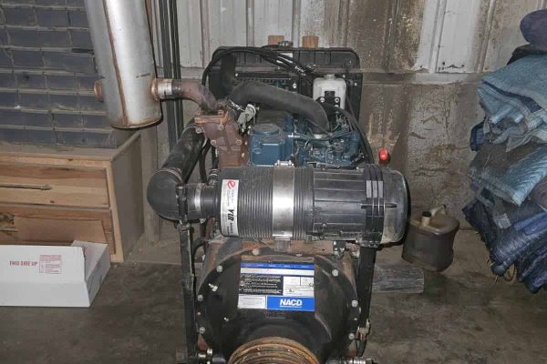 Kubota V3600 diesel power unit with exhaust and cooling system in a workshop.