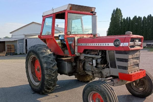 Massey Ferguson 1130 tractor with enclosed cab and large rear tires.