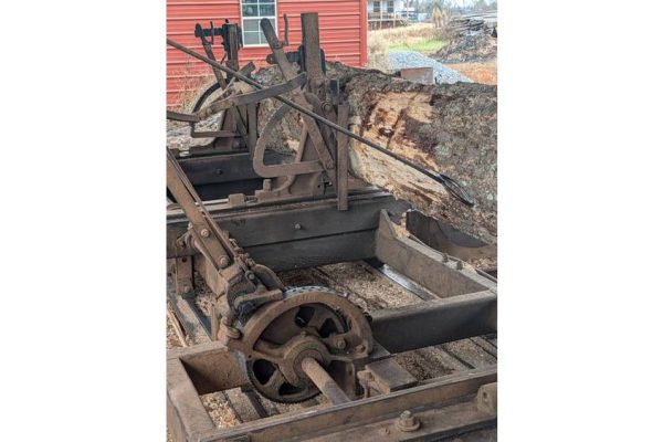Old industrial rail grinder machine on tracks, used for railway maintenance and repair.