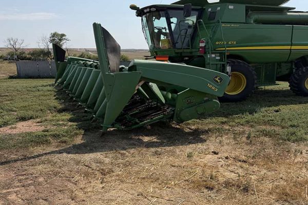 2001 John Deere 1293 combine harvester with green body and large header attachment.